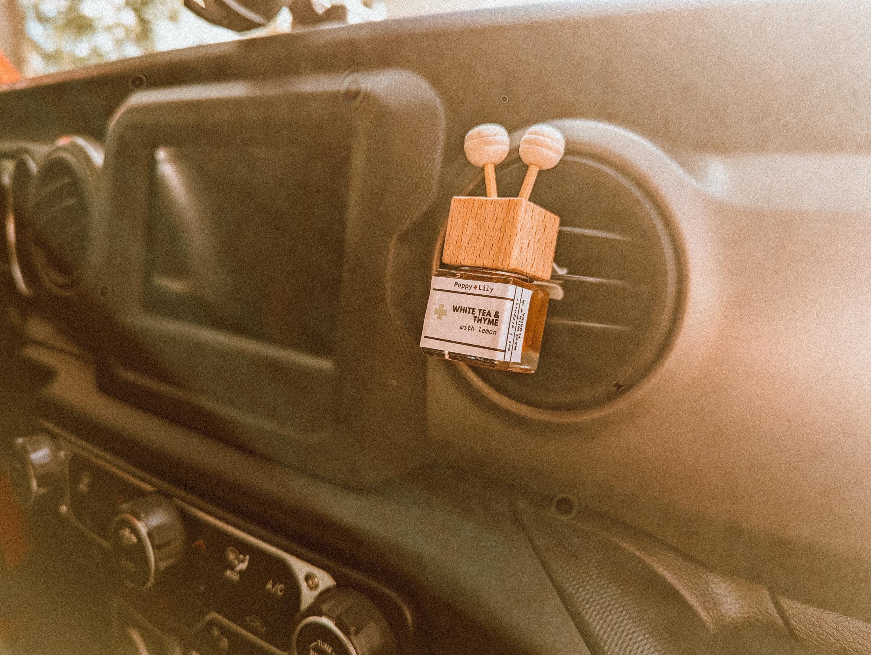 Car air freshener with wooden design on a car dashboard